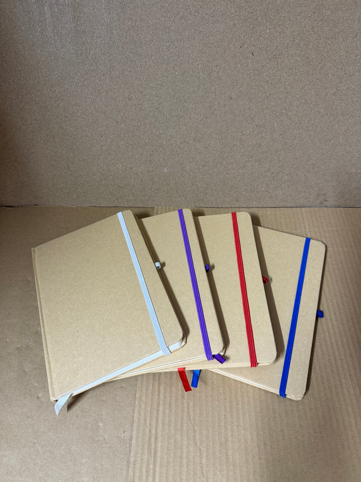 Box of 50 A5 hardback notebooks with coloured closure