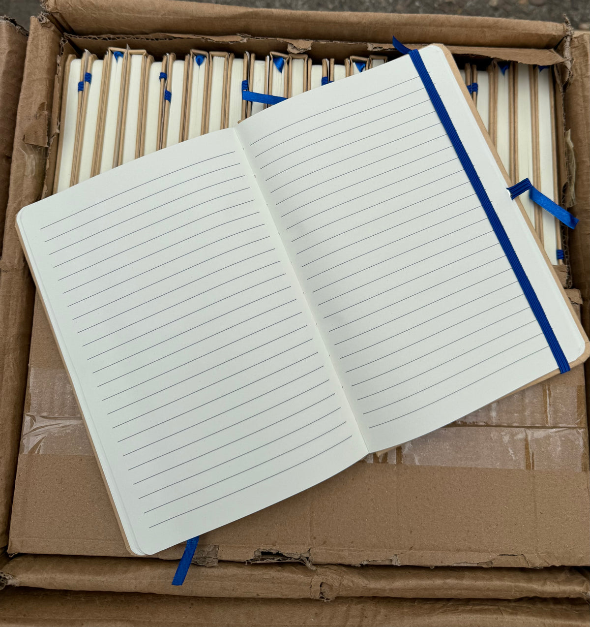 Box of 50 A5 hardback notebooks with coloured closure